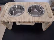 Pet double high feeder in pine wood with stainless steel bowls.