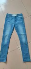 jeans rasgados y estiramiento de ajuste regular de la subida media